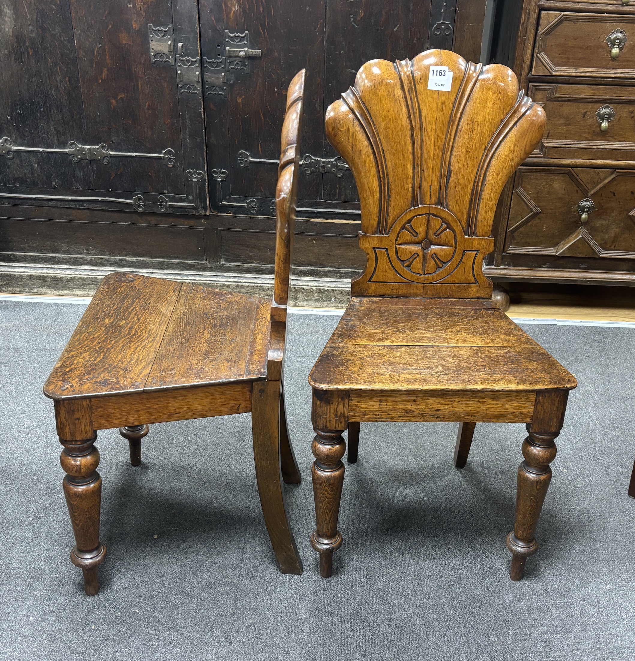 A pair of Victorian carved oak hall chairs, width 40cm, depth 40cm, height 87cm